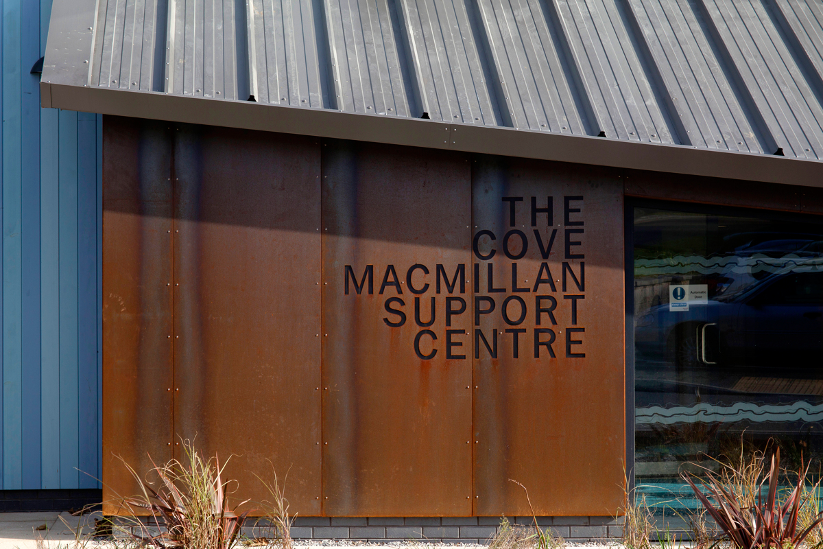 The new Cove Macmillan Centre has a Cor-Ten steel sign chosen for it's texture and changing weathered appearance. Image courtesy of Mike Newman