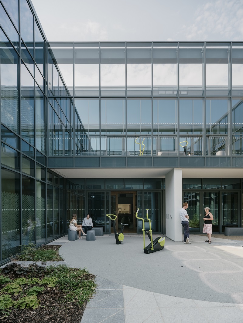 To support physical health, inclusive exercise equipment is provided in the courtyards