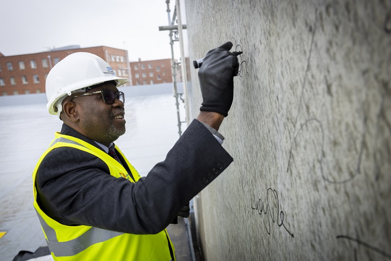 The topping-out ceremony saw key  stakeholders signing the concrete stair core of the new building